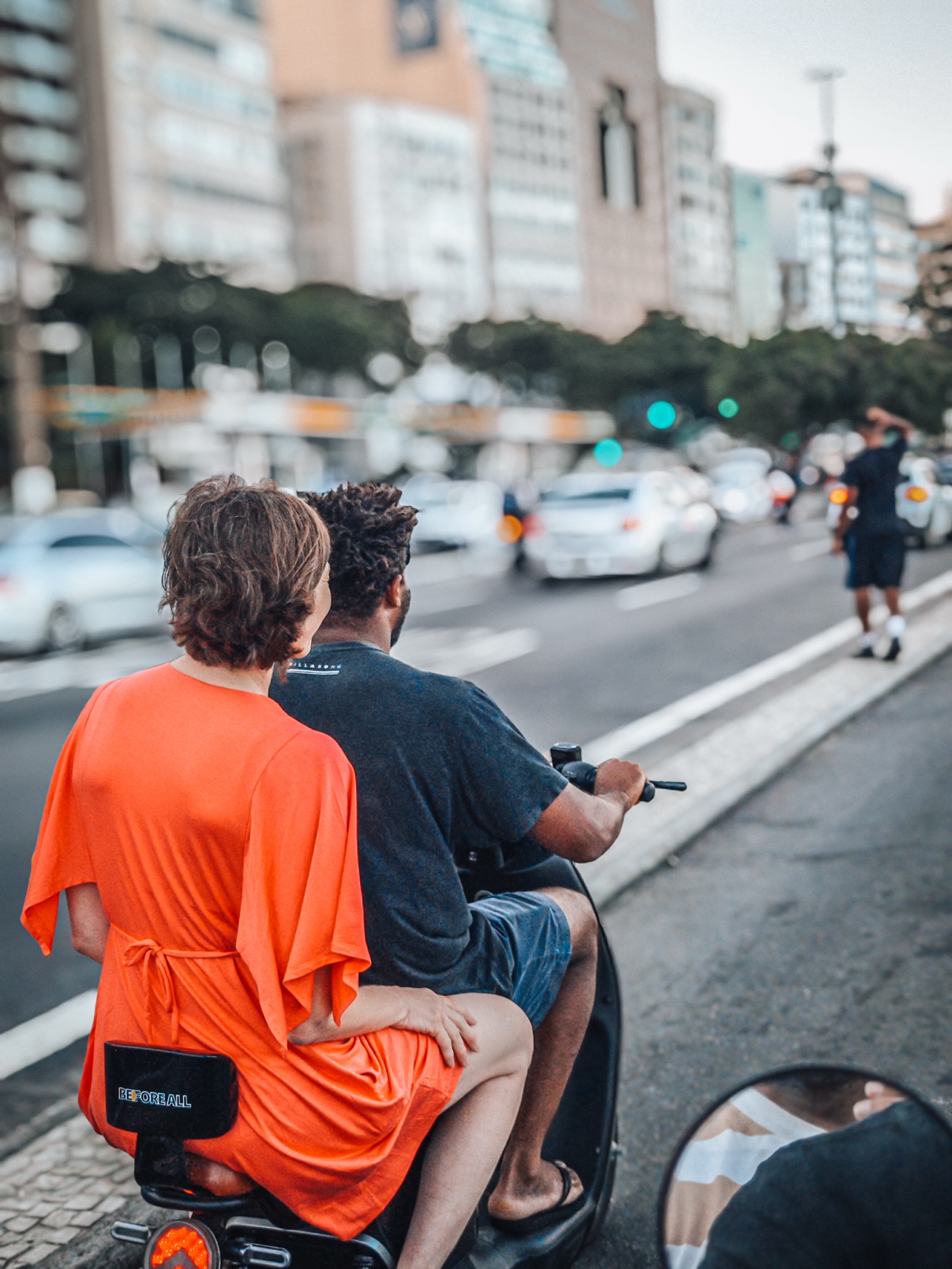 Riding a scooter through the streets of Rio de Janeiro