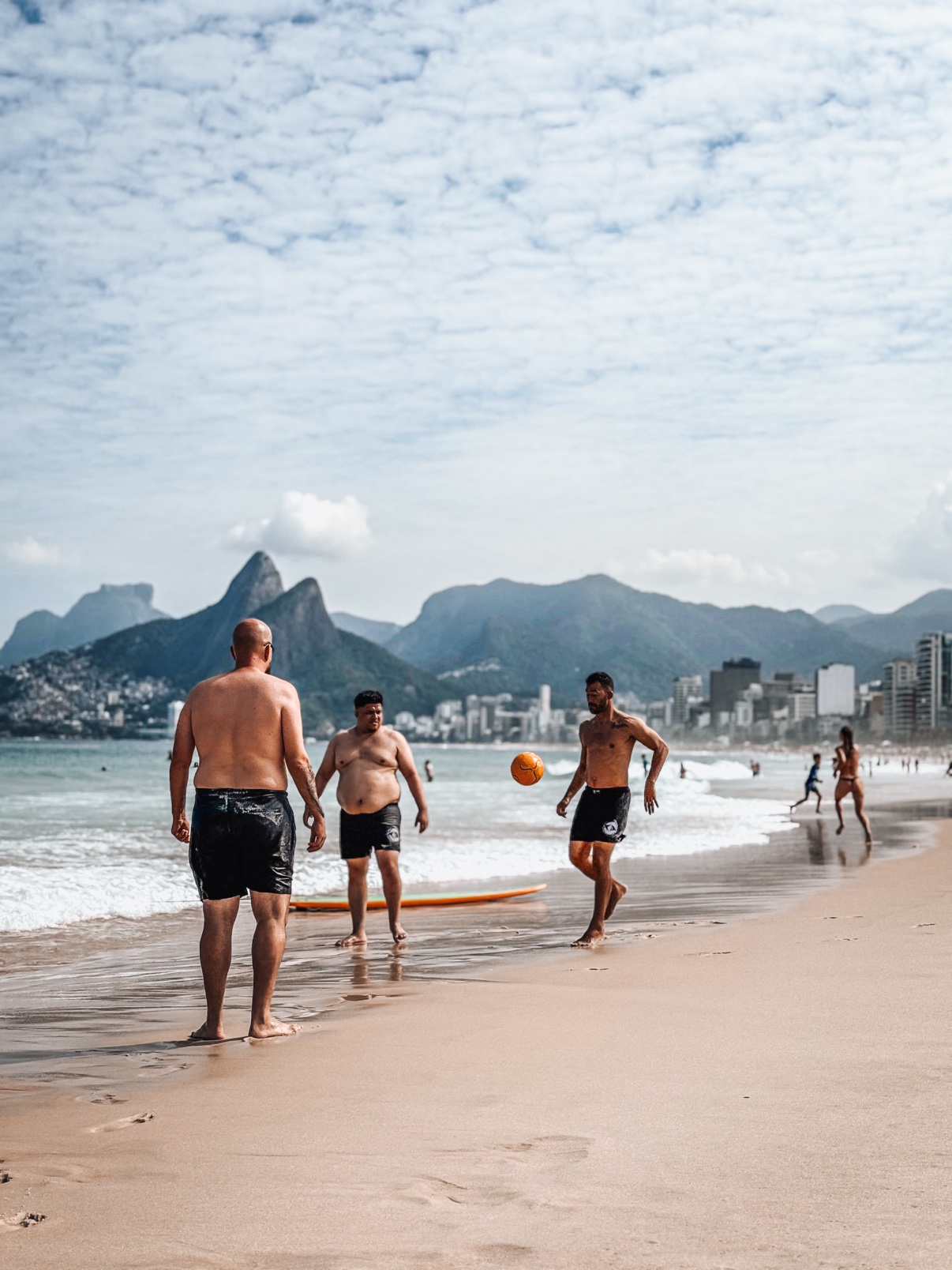 OSS Rio Tour travelers playing soccer on the beach in Rio de Janeiro