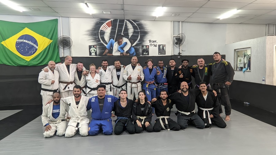 OSS Rio Tour group on the mats under the Brazilian flag at a Rio academy